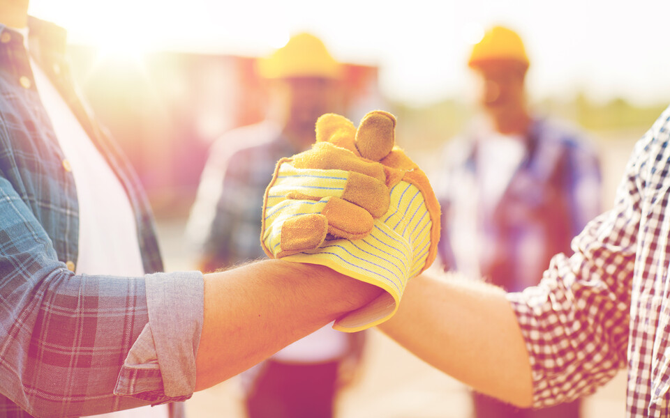 Workers clasping hands