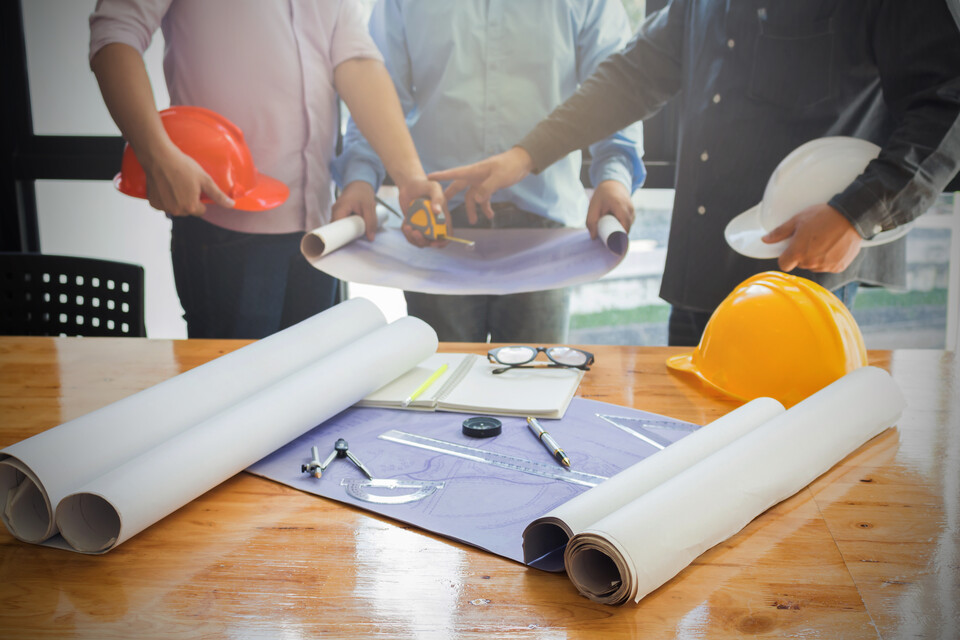 Workers reviewing blueprints